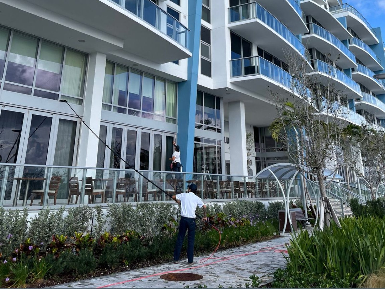 Pink's Windows crew using a water-fed pole on a Palm Beach high-rise